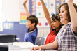 © Austockphoto - Students raising their hands to answer a question