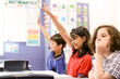 © Austockphoto - Three Students in the classroom sitting at their desk