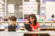 © Austockphoto - Front view of students with headphones and iPads in the classroom