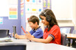 © Austockphoto - Students in the classroom looking at their iPads and smiling