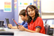 © Austockphoto - Students with headphones and digital devices in the classroom