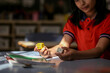 © Austockphoto - girl student at her desk working on maths problems using dice