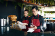 © DragonImages - Bartender and waiter preparing restaurant for opening