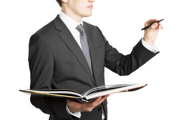 Wall Mural - A businessman with a pen and an open book, isolated on a white background, depicting a concept of organization and planning