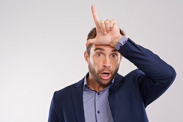 Wall Mural - Portrait, business and man with loser gesture, fail and facial expression on a white studio background. Face, employee and entrepreneur with emoji and L sign with social media or review with feedback