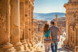  Couple Walking Through Ancient Ruins on a Sunny Day in a Historic Destination
