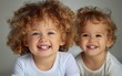© hakule - Two young children are smiling and posing for a picture