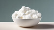 A white bowl filled with white clouds. The bowl is on a wooden table