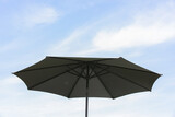 Fototapeta Tęcza - Beautiful beach umbrella, with blue sky behind it, close-up