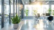 © Nuchylee - Blurred modern office interior with desks, computer and plant in background in the style of white color