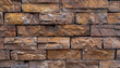 Close-up of a brown brick wall made of rectangular bricks, classic building material made of rock, banner, front view