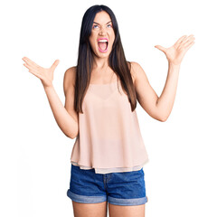 Poster - Young beautiful caucasian woman wearing casual clothes crazy and mad shouting and yelling with aggressive expression and arms raised. frustration concept.