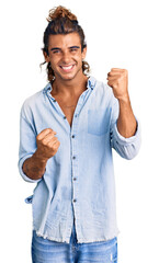 Wall Mural - Young hispanic man wearing summer style celebrating surprised and amazed for success with arms raised and eyes closed. winner concept.