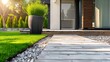 Stylish suburban home entrance featuring a pot of grass and a wooden path
