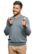 © Krakenimages.com - Handsome hispanic man wearing casual clothes pointing fingers to camera with happy and funny face. good energy and vibes.