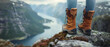 View from mountains lake river fjord. Feet with hiking shoes from a woman standing resting on top of a high hill or rock