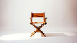 A wooden chair with a brown leather seat and back. The chair is empty and sitting on a white background