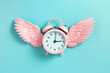 Alarm clock with angel wings flying on pastel background. Time flies concept, time management, free time. Time of flight. Day schedule, lack of time, running out of time, countdown, hurry, rush.