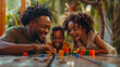 Family of three smiling and playing with blocks together.
