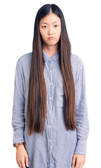 Sticker - Young beautiful chinese woman wearing casual shirt depressed and worry for distress, crying angry and afraid. sad expression.