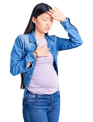 Canvas Print - Young beautiful chinese woman pregnant expecting baby touching forehead for illness and fever, flu and cold, virus sick