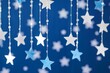 Hanging paper stars on a blue background, concept of party decoration and celebration