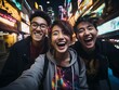 Friends Taking a Selfie on a Vibrant City Street at Night