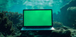 A mockup of an laptop with a green screen, underwater