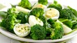  a plate of broccoli, eggs, and spinach on a white tablecloth with a green napkin.
