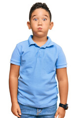 Sticker - Little boy hispanic kid wearing casual clothes puffing cheeks with funny face. mouth inflated with air, crazy expression.