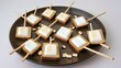 Marshmallows arranged artistically on toothpicks, creating a playful and creative display.
