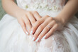 Wedding nail design of the bride, beautiful hands of the bride with well-groomed manicure