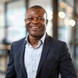 © serz72 - Smiling African American businessman 50-60 years old, active business man against the background of his office