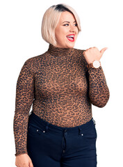 Wall Mural - Young blonde plus size woman wearing casual leopard t-shirt smiling with happy face looking and pointing to the side with thumb up.