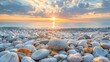 Pebble beach at sunset with vibrant sky and reflective sea. Close-up of smooth stones with sunset colors for design and print