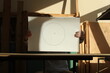 Drawing with circle on a white paper in the hands of a young man and contrasting sunlight. Photo was taken 3 February 2024 year.