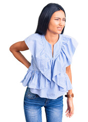 Sticker - Young beautiful latin girl wearing casual clothes suffering of backache, touching back with hand, muscular pain