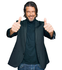 Wall Mural - Middle age handsome man wearing business clothes approving doing positive gesture with hand, thumbs up smiling and happy for success. winner gesture.