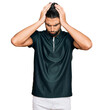 © Krakenimages.com - Young man with beard wearing sportswear suffering from headache desperate and stressed because pain and migraine. hands on head.