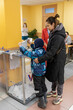 Russia. Saint-Petersburg. A family throws a ballot into the ballot box for the presidential election.