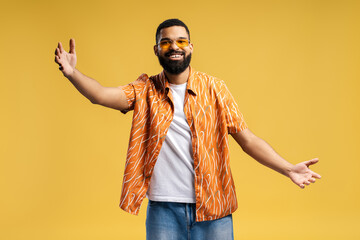 Wall Mural - Happy smiling African American man wearing stylish casual clothes and sunglasses with open arms