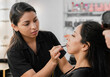 © Patricio - Close-up of Hispanic cosmetologist doing makeup on her client at the beauty salon.