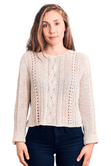 Poster - Young beautiful blonde woman wearing casual sweater relaxed with serious expression on face. simple and natural looking at the camera.