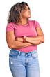 Young african american plus size woman wearing casual clothes looking to the side with arms crossed convinced and confident