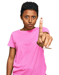 Canvas Print - Young african american woman wearing casual clothes pointing with finger up and angry expression, showing no gesture