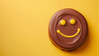 Smiling Chocolate Emoji on Vibrant Yellow Background