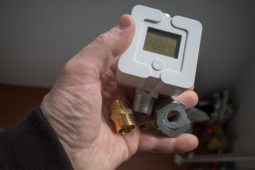 a man holds a new gas meter in his hands