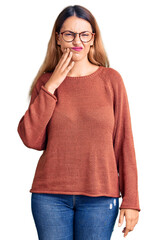 Wall Mural - Beautiful young woman wearing casual clothes and glasses touching mouth with hand with painful expression because of toothache or dental illness on teeth. dentist