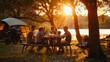 A family gathered for a barbecue dinner at their campsite as the sun set.