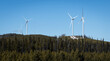 Wind turbines on crest of forested hill